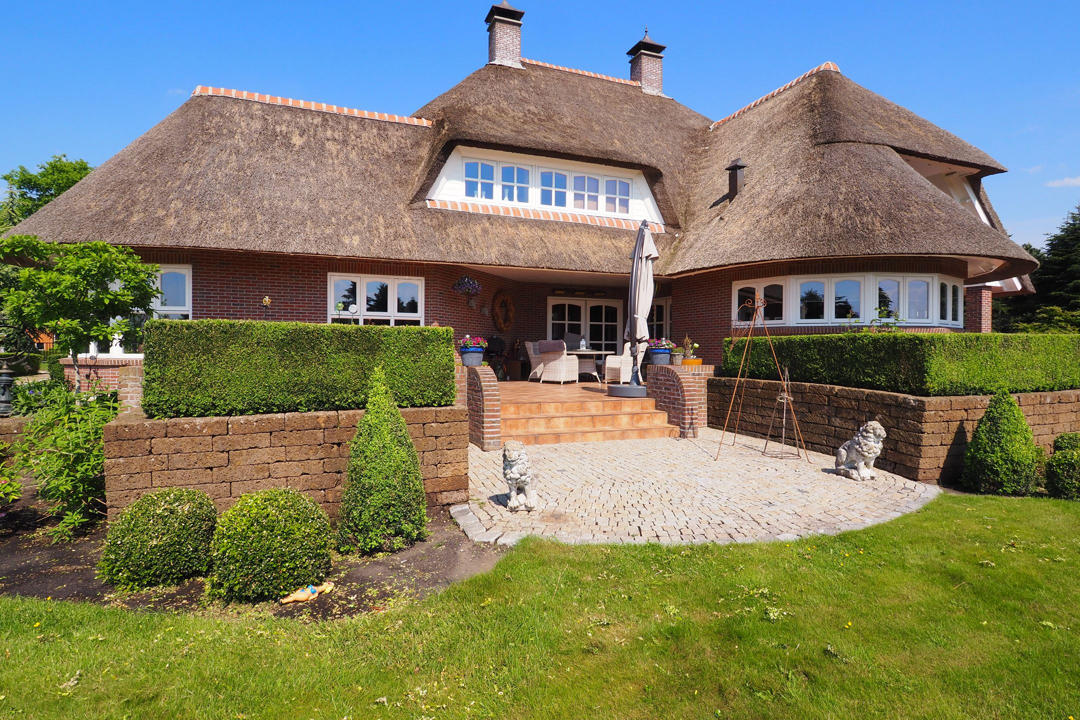 Detail van de woning met terras en beplanting